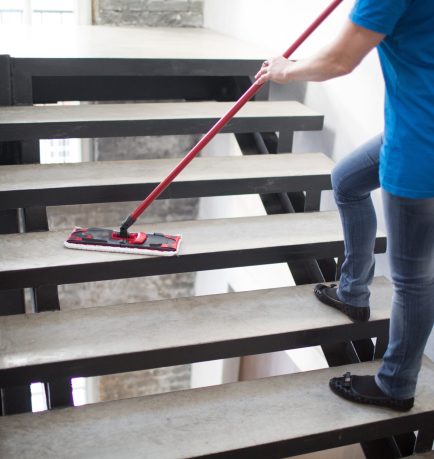 Cleaning service concept. Woman clean stair at home.